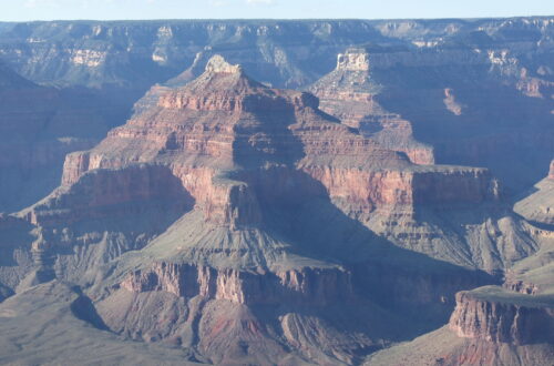 The Grand Canyon. As seen from a viewpoint on the south rim. High peaks in different colors and below the Colorado river in the valley.